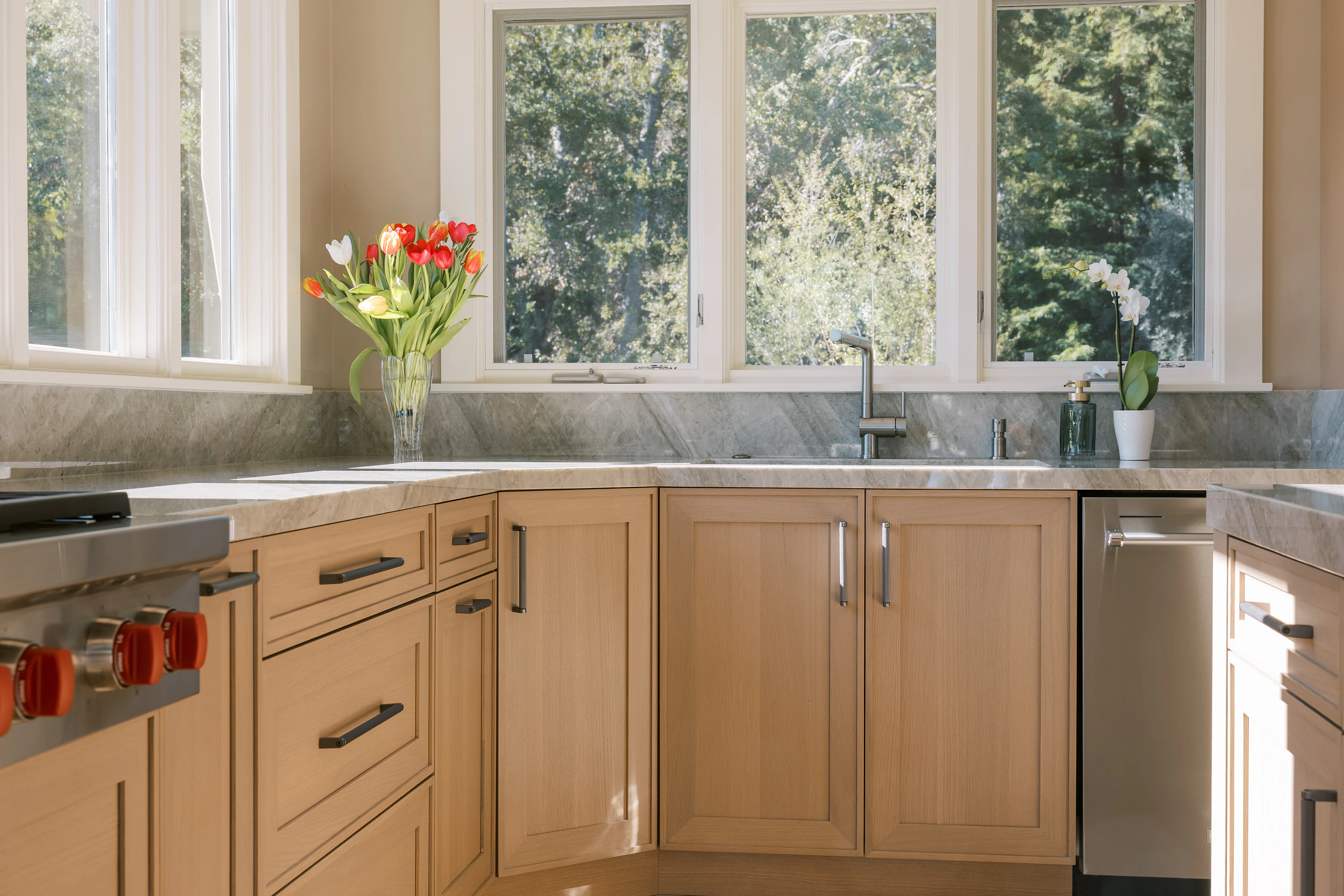 Light wood Wood-Mode kitchen with custom drawers and a professional range