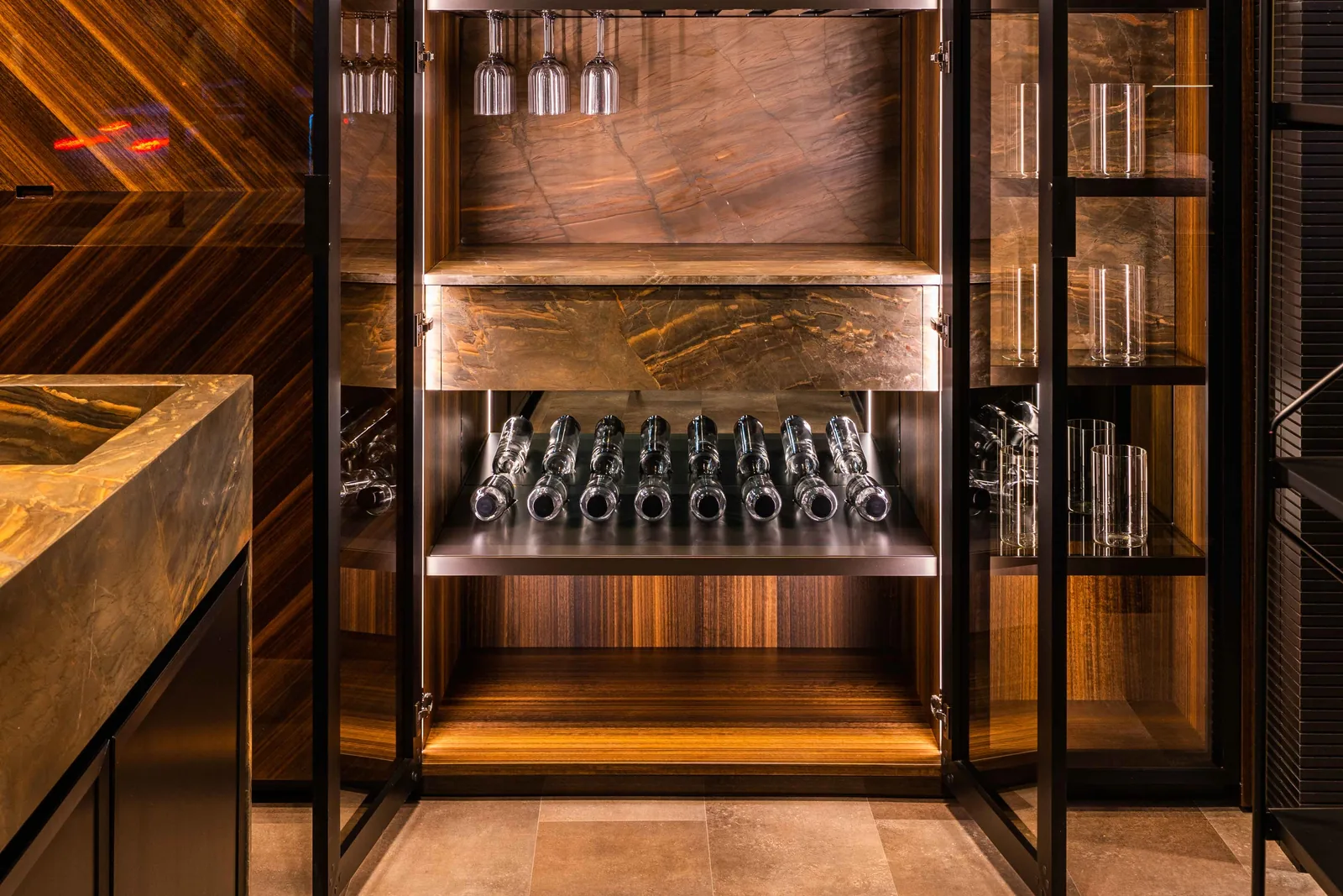 Glass-door tall cabinet with a stone drawer in DOCA's Madrid showroom