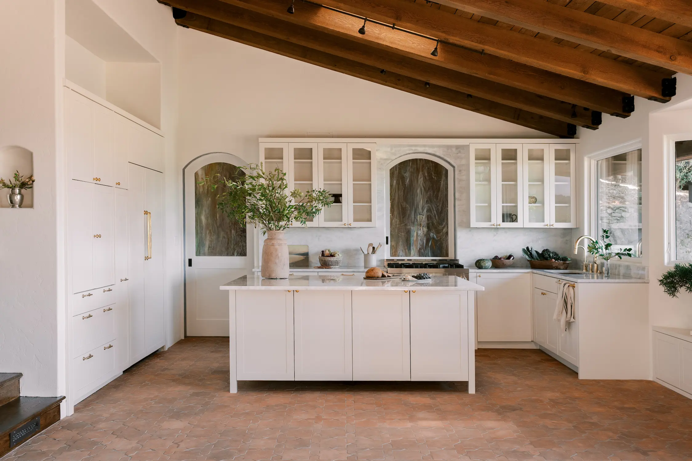 Transitional white Crystal kitchen with a beamed ceiling and a glass-front hutch
