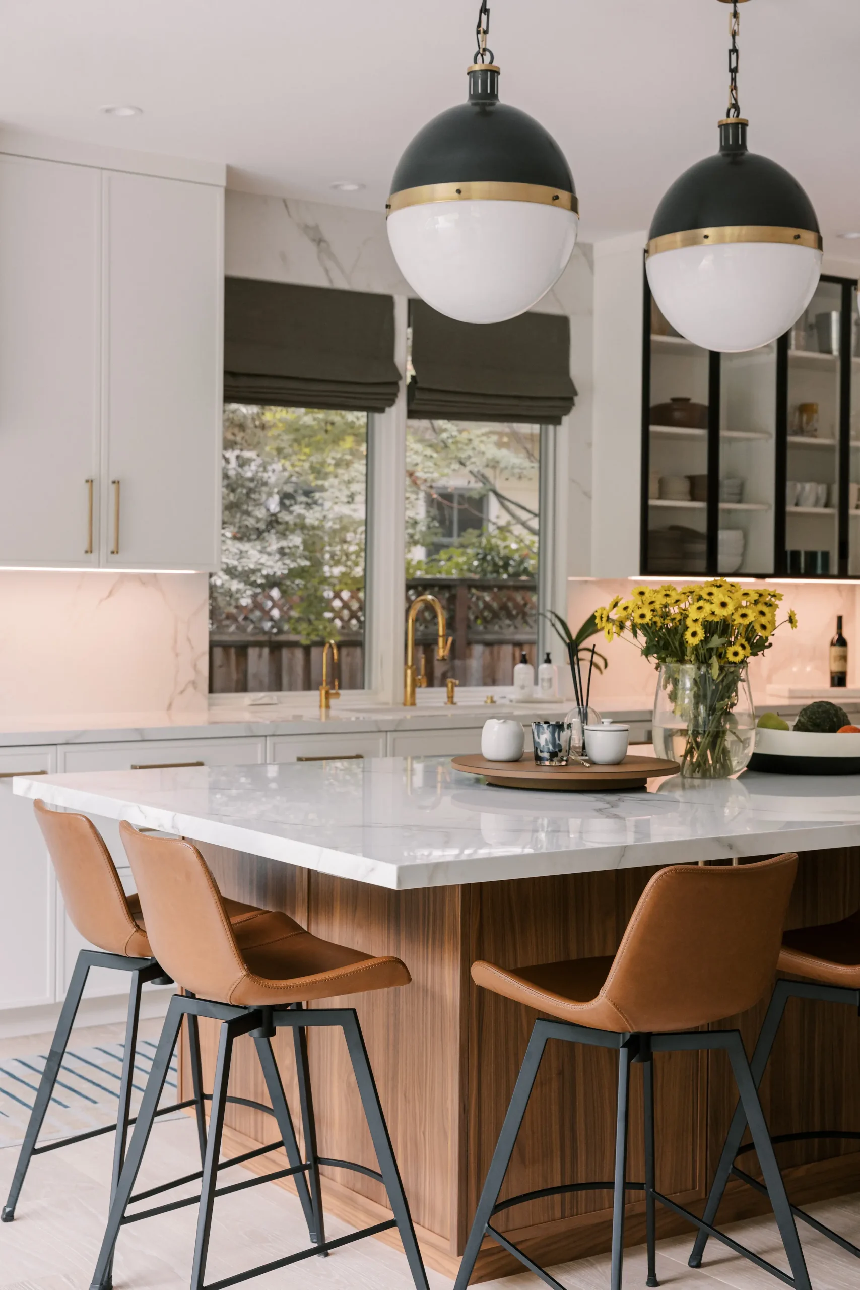 Transitional Crystal kitchen with white cabinets and a dining table under a chandelier