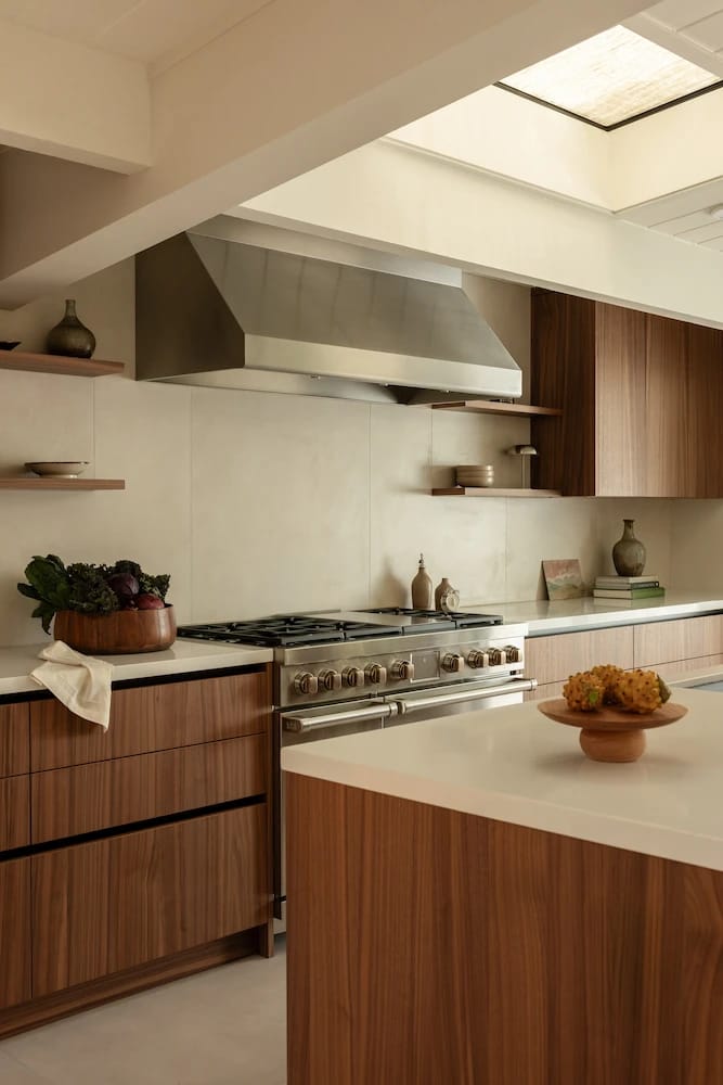 Wood slab cabinets with an undercounter oven, open shelves and toe-kick lighting