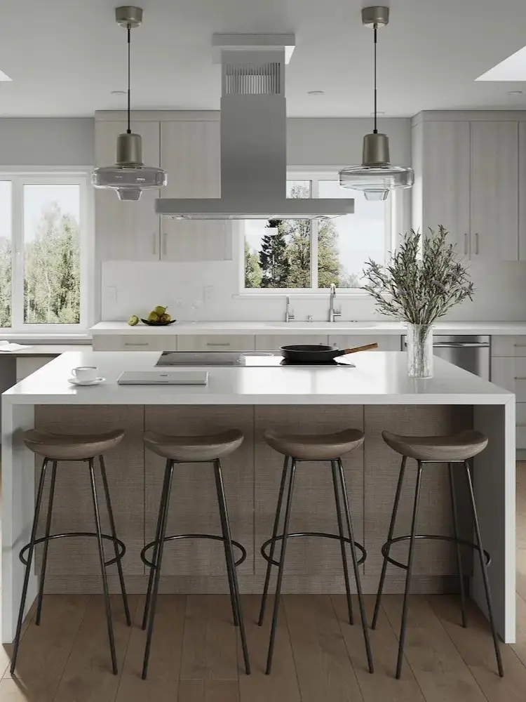 Modern kitchen with large island, pendant lighting, and integrated desk workspace