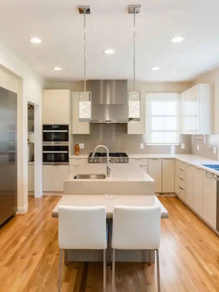 Kitchen with beige cabinets, central island, and stainless steel appliances