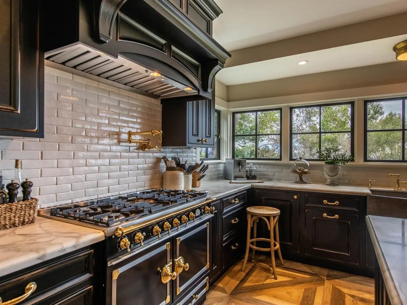 Traditional kitchen with dark Crystal cabinets, a subway tile wall and a range