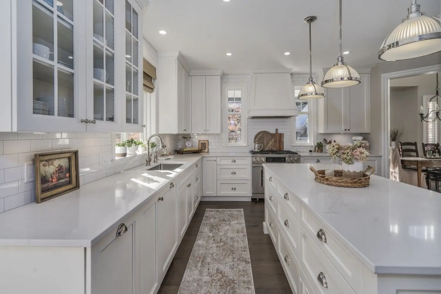 Beautiful kitchen with white glass door cabinets and elegant pendant lights