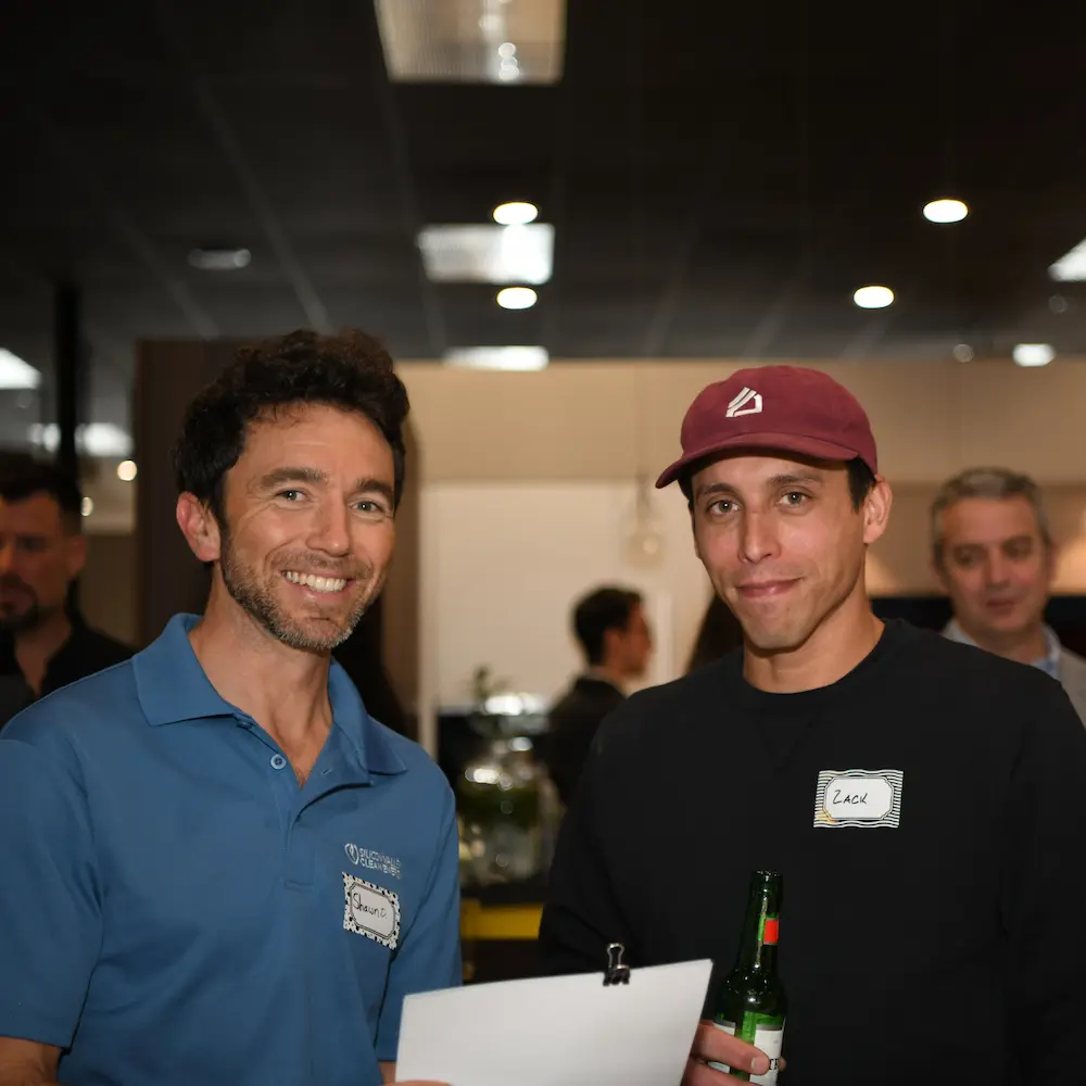 a couple of men smiling at camera
