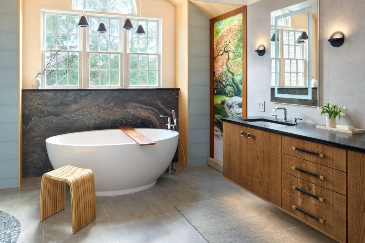Spa-inspired bathroom with freestanding tub, dark marble backsplash, and wood cabinetry for a nature-inspired retreat