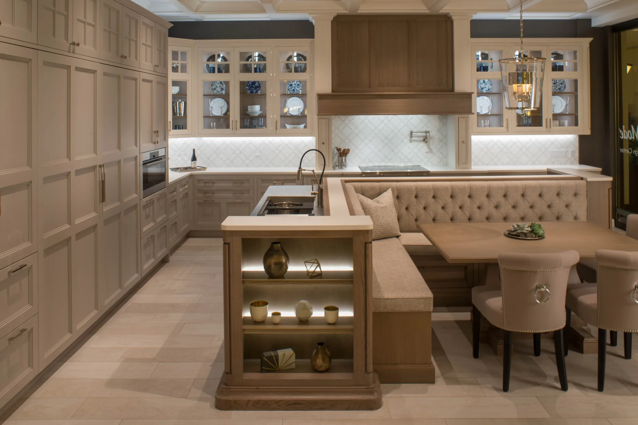 Traditional Wood-Mode kitchen with a paneled hood and a built-in banquette