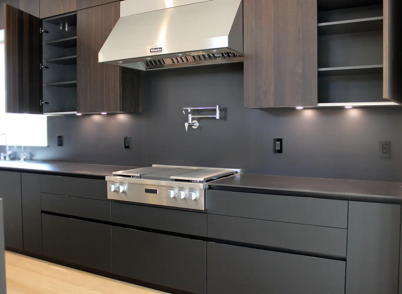 Kitchen island with open shelving, hidden storage solutions, and matte black finish